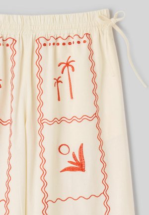 Tissu crème avec palmiers et soleil brodés en orange, taille élastique et détail de nouage latéral.