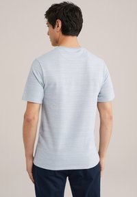 T-shirt azzurro chiaro a maniche corte realizzato in tessuto morbido, con un delicato motivo a righe e un classico colletto a girocollo, visto da dietro.
