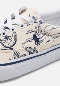 Plátěné sneakers mají potisk mapy v námořnické modři, bílé tkaničky a bílou gumovou podrážku s texturovaným gripem. Obsahují vyšívané detaily.
