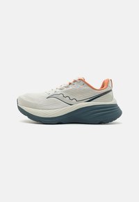 Chaussure de course avec une tige en maille blanche, des accents corail et une semelle extérieure en caoutchouc bleu foncé. Présente des éléments de design ondulés et une semelle intermédiaire rembourrée.