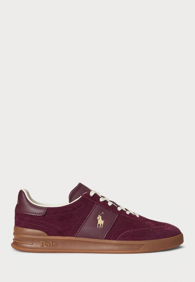 Maroon suede and leather sneaker with white laces, beige logo emblem on side, brown sole embossed with "Polo," and padded collar interior.