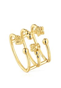 Gold-colored ring featuring multiple intertwined bands, spherical and floral accents, and varied textures, all with a polished finish.