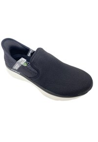 Bottines en toile marine à enfiler, dotées d'un bout arrondi et d'une semelle épaisse blanche avec un bord texturé. Étiquette visible sur la languette.