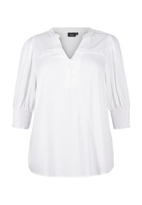 Blouse blanche avec un décolleté en V, des manches bouffantes trois-quarts et des détails de boutons. Fabriquée dans un tissu texturé avec des poignets smockés et une coupe décontractée.