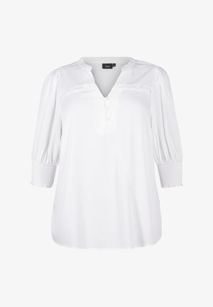Blouse blanche avec un décolleté en V, des manches bouffantes trois-quarts et des détails de boutons. Fabriquée dans un tissu texturé avec des poignets smockés et une coupe décontractée.