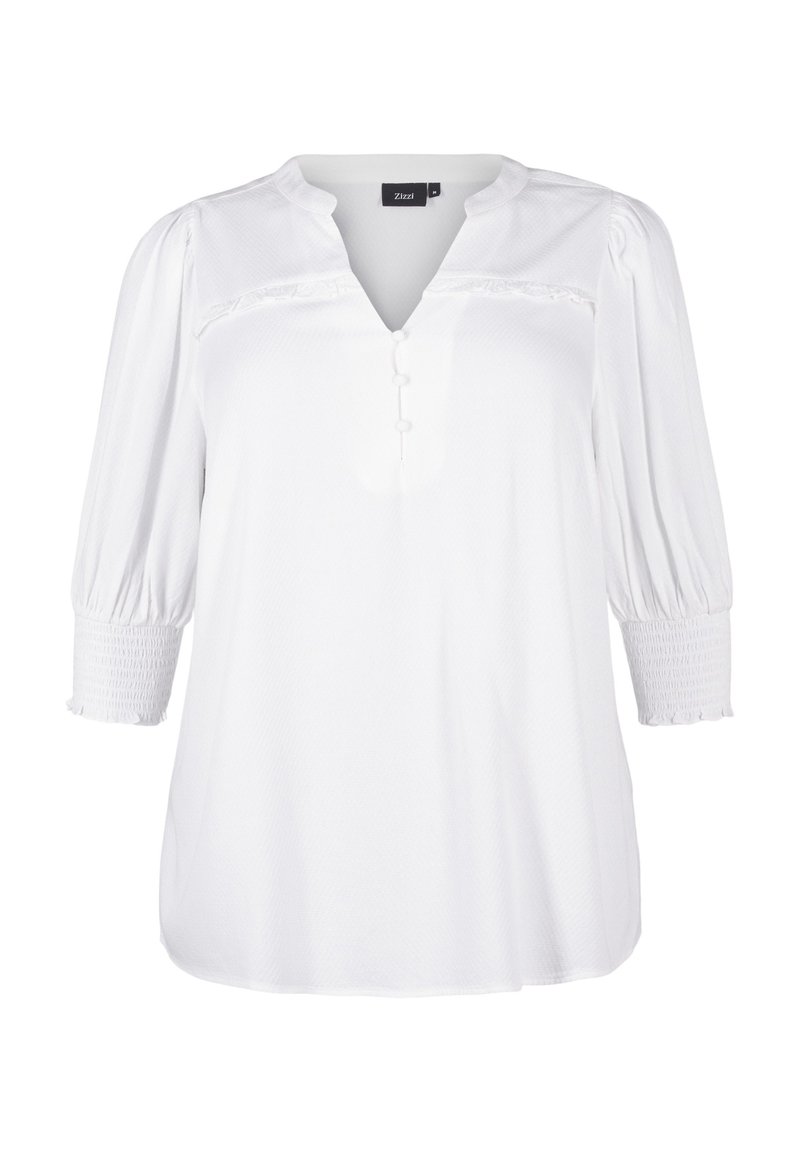 Blouse blanche avec un décolleté en V, des manches bouffantes trois-quarts et des détails de boutons. Fabriquée dans un tissu texturé avec des poignets smockés et une coupe décontractée.