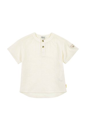 Kurzes, strukturiertes T-Shirt für Kleinkinder mit kurzen Ärmeln, zwei Knöpfen vorne und einem kleinen Bären-Aufnäher am linken Ärmel.