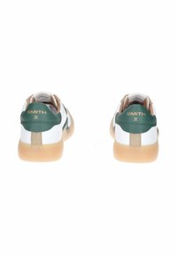 Sneaker in pelle bianca con dettagli verdi e beige, dotati di suola in gomma e branding sul tallone e sui lati.