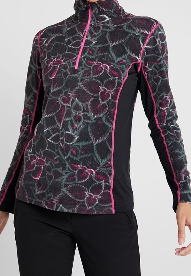 Pull-over en polaire à fleurs ajusté avec une fermeture éclair rose et des coutures assorties, porté avec un pantalon noir, visible du cou jusqu'aux hanches.