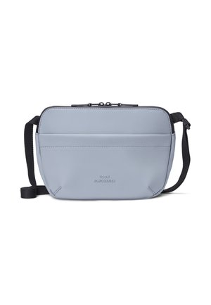Light blue rectangular crossbody bag with black adjustable strap and dual zipper closure, featuring a front pocket and small embossed logo.