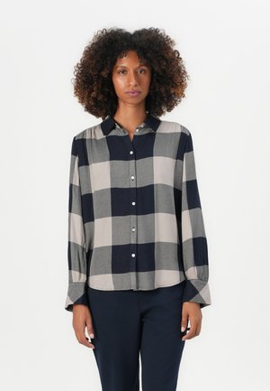 Long-sleeve, button-up shirt featuring a gray and navy checkered pattern, collared neck, and cuffed sleeves. Made from a smooth fabric.