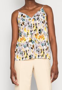 Ärmlös V-ringad topp med ett flerfärgat blommönster i nyanser av gult, blått och grått, tillverkad av ett strukturerat tyg.