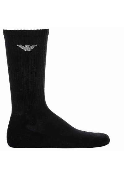 Calcetines negros de canalé con una longitud hasta la mitad de la pantorrilla. Presentan un logotipo en blanco cerca de la parte superior. Fabricados con un tejido suave y elástico.