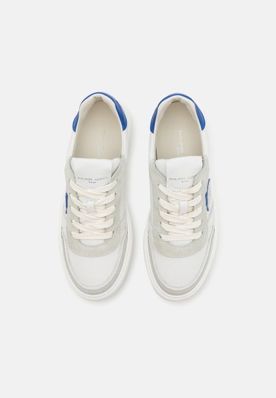 Baskets en cuir blanc et gris avec des accents bleus, dotées d'un laçage, d'un bout rond et de panneaux en suède texturé. Logo en texte sur la languette.