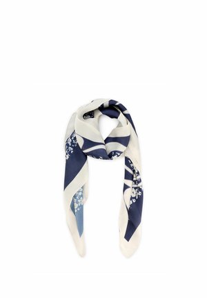 Jedwabna chusta z granatowymi, białymi i jasnoniebieskimi geometrycznymi i kwiatowymi wzorami, złożona i luźno zawiązana w węzeł.