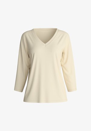 Light beige v-neck tunic, featuring three-quarter sleeves and smooth, soft fabric. Simple design with no patterns or embellishments.