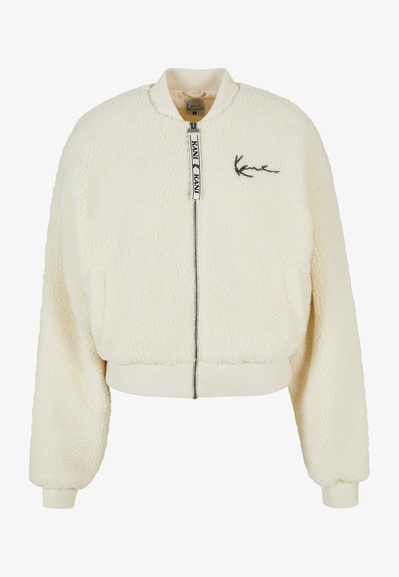 Kreemikaalune bomber-jakk, mis on valmistatud tekstureeritud kunstkarvast, ribiga mansettide ja tõmblukuga. Rinnal on tagasihoidlik logode embleem.