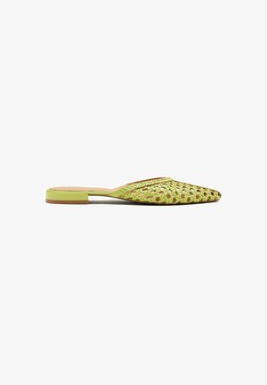 Green woven slip-on mules with a pointed toe, flat heel, and a textured pattern. The sole is a contrasting light brown color.