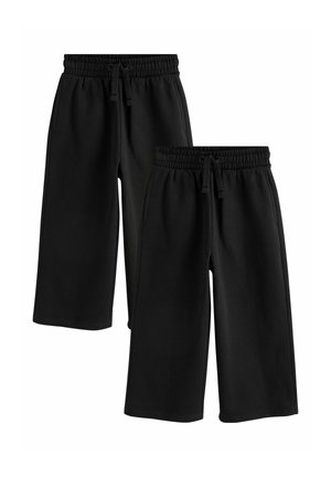 Zwei Paare schwarze, weit geschnittene, gekürzte Hosen mit elastischen Bund und Kordelzügen, gezeigt vor weißem Hintergrund.