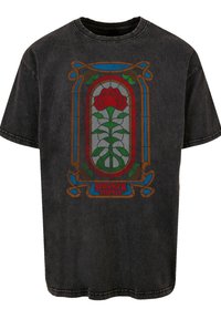 Black cotton T-shirt featuring a graphic print of a red rose and green vines in a stained glass design, with "STRANGER THINGS" text at the bottom.