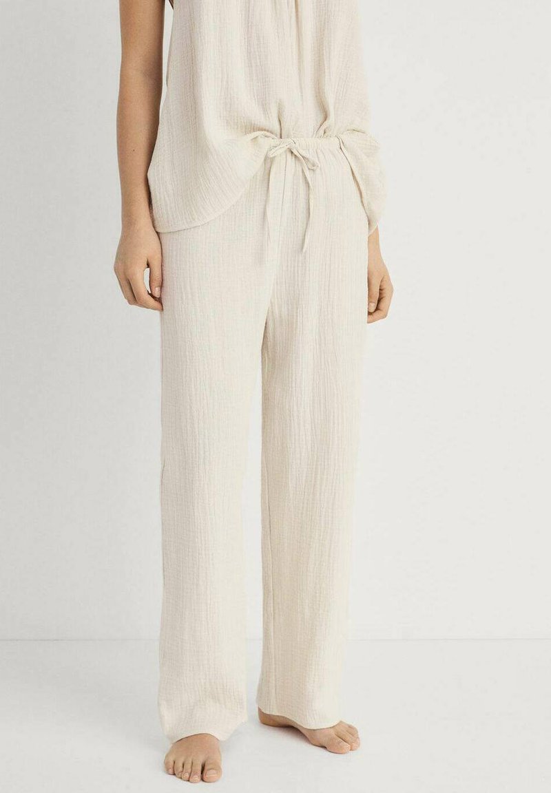 Ljust beige, texturerade loungebyxor med en lös passform och resårmed bälte, parat med en matchande ärmlös topp. Mjuk, andningsbar tyg.
