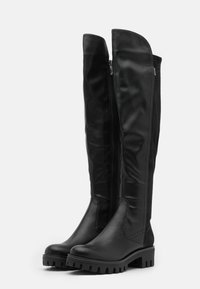 Stivali neri in pelle sopra il ginocchio con zip laterale, parte superiore texturizzata e suola in gomma spessa e scanalata.