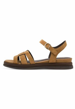 Sandale en daim marron avec plusieurs lanières, boucle à la cheville, semelle rembourrée et petite plateforme. Conçue pour le confort et la stabilité.