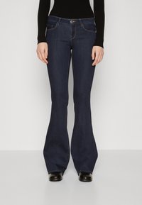 Mørkeblå slengbukser med fem lommer, glidelås og kontrastsøm. Glatt denimtekstur og en tettsittende midje.