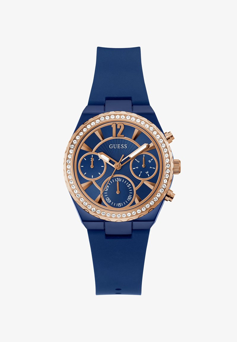 Reloj con correa de silicona azul, bisel de oro rosa, acentos de cristal y una esfera azul que presenta tres subesferas y marcadores de hora audaces.