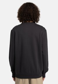 Dark grey sweatshirt with long sleeves, ribbed cuffs, and hem. Features a crew neck and a smooth, soft texture. View from the back.