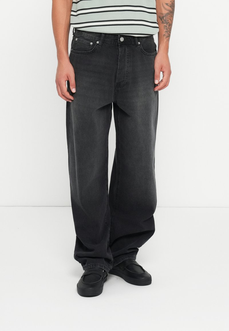 Black, wide-leg jeans in denim fabric with a faded finish; features a classic five-pocket design and metal hardware for closure.