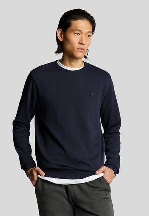 Felpa blu navy con maniche lunghe, caratterizzata da un collo rotondo e un sottile dettaglio del logo sul petto. Realizzata in un morbido tessuto testurizzato.