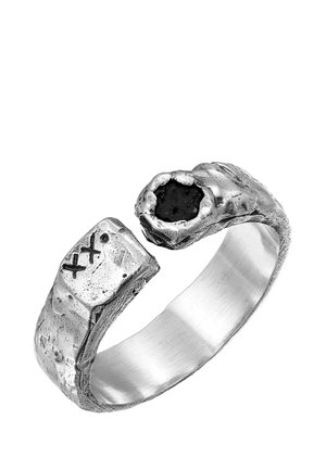 Silver ring with a textured, uneven surface, featuring a rough edge and a black stone setting. Designs include X-shaped engravings.