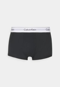 Sorte boxer shorts laget av myk bomullsblanding, med en hvit elastisk midjebånd med svart "Calvin Klein" logo. Glatt, tettsittende design.