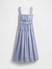 Blå blomster maxi-kjole med smocket midje, firkantet utringning og volanger på stroppene. Stoffet har et delikat mønster og en flytende skjørt.