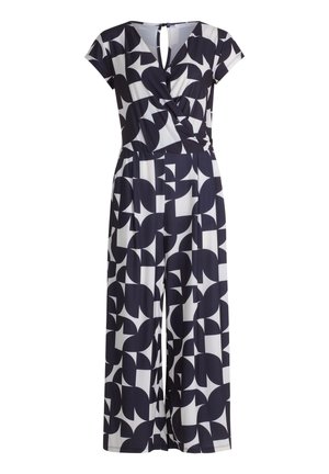 Sort-hvidt geometrisk mønstret jumpsuit med korte ærmer, V-halsudskæring og indsnævret talje, bukser med vide ben og nøglehulsknaplukning bagpå.