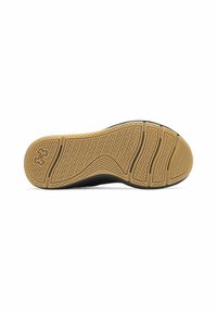 Black sole with a textured rubber pattern in a zigzag design, featuring a tan midsole and multiple grooves for flexibility and traction.