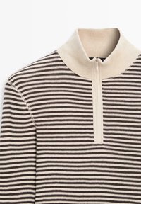 Zip-neck sweater featuring horizontal brown and cream stripes, ribbed collar, and soft knit texture. Accented with a zipper at the front.