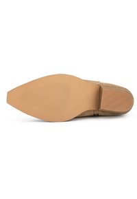 Suela de zapato de ante beige con una forma elegante y alargada, textura suave y fondo de goma con ranuras horizontales para mayor tracción.