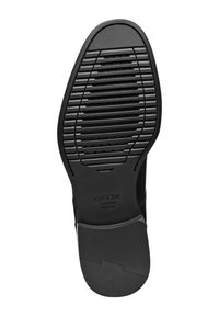 Suola in gomma nera con una superficie testurizzata, caratterizzata da scanalature e motivi circolari. Stampa "GEOX ITALIAN PATENT" sul lato.