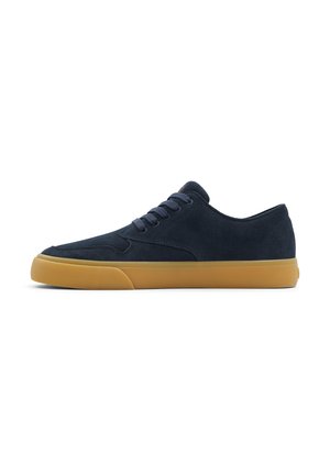 Navy suede sneaker with a low-top design, round toe, and rubber gum sole. Six eyelets with matching laces, minimalist style with no visible branding.