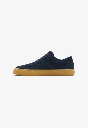 Navy suede sneaker with a low-top design, round toe, and rubber gum sole. Six eyelets with matching laces, minimalist style with no visible branding.