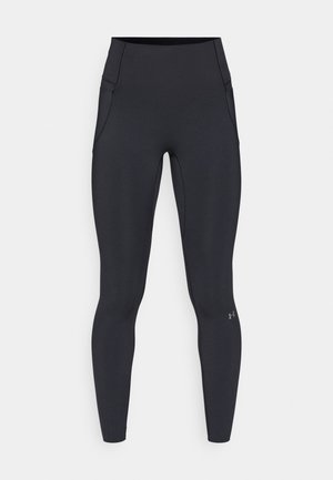 Leggings de sport noirs en tissu lisse et extensible. Taille haute avec poches latérales et petit logo sur la partie inférieure de la jambe.