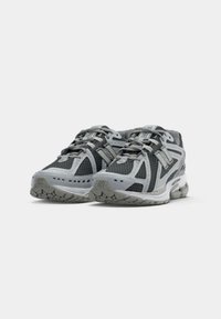 Pair of gray and black athletic running shoes with laces, cushioned soles, and branded logos on the sides and tongues.