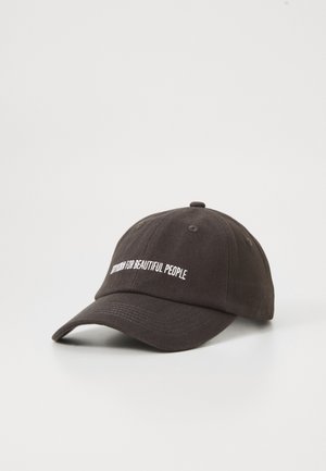 Black baseball cap with a curved brim, featuring white embroidered text that reads "Nothing for Beautiful People." Cotton material.