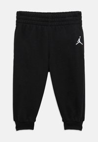 Μαύρο παντελόνι φόρμας από μαλακό υλικό, με ελαστική μέση και μανσέτες. Στο αριστερό πόδι είναι κεντημένο το λευκό λογότυπο Jordan.