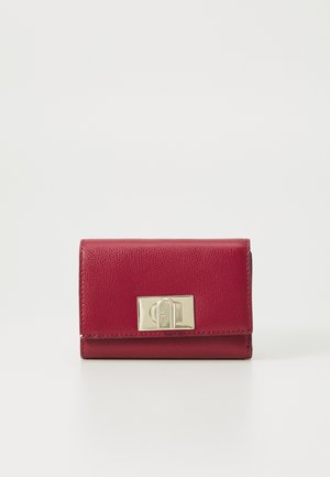 Red leather wallet with a textured finish, featuring a gold-tone clasp. Compact rectangular shape with rounded edges. Minimalist design.