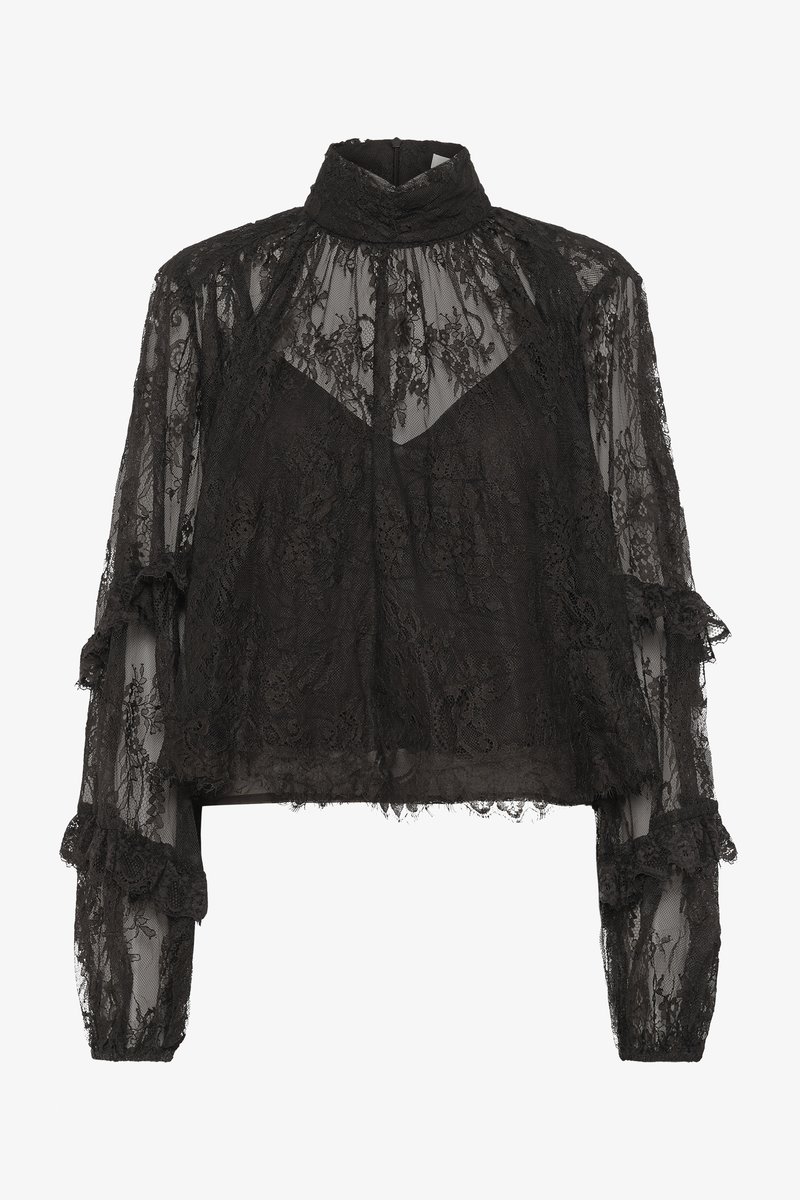 Blusa in pizzo nero con colletto alto, maniche lunghe trasparenti, polsini arricciati e un intricato motivo floreale. Design cropped con un look stratificato.