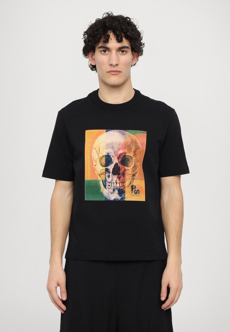 Black t-shirt featuring a colorful skull graphic on the front, with geometric shapes in vibrant shades of orange, green, and blue.