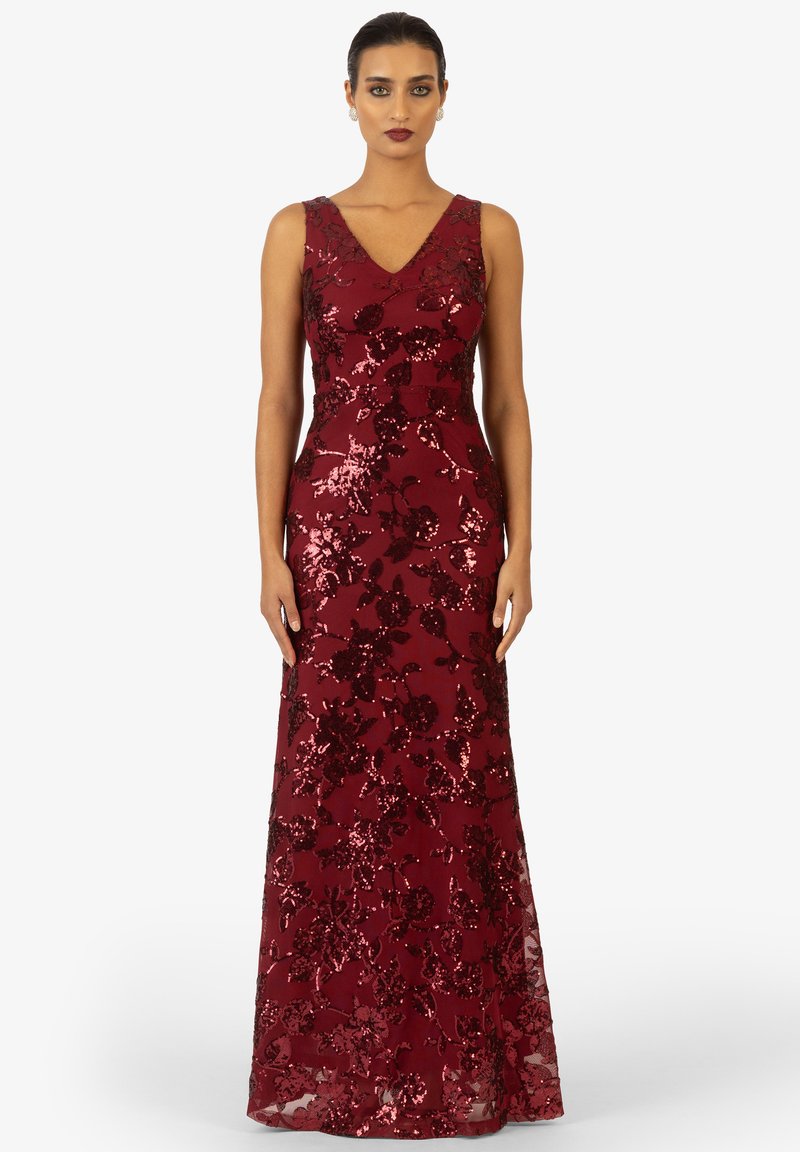 Abito lungo color bordeaux con scollatura a v, motivo floreale con paillettes, corpino aderente e gonna fluida. Tessuto liscio, design senza maniche.